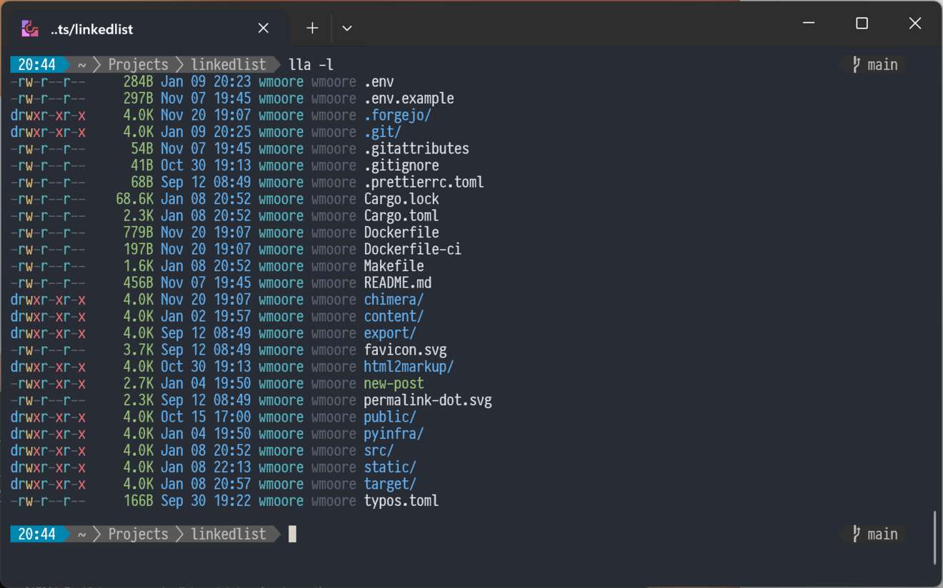 lla -l run in a terminal. The file listing includes permissions, size, last modified, user, group, and the file name. Colours are used to highlight the different parts.